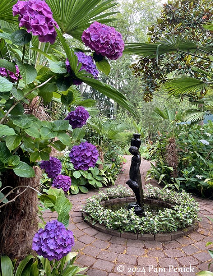 Tiki-style pond and lush courtyard at the Galicic Garden